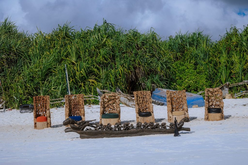Group photograph of carved furniture and thrones on the beach — 0S7A4995.