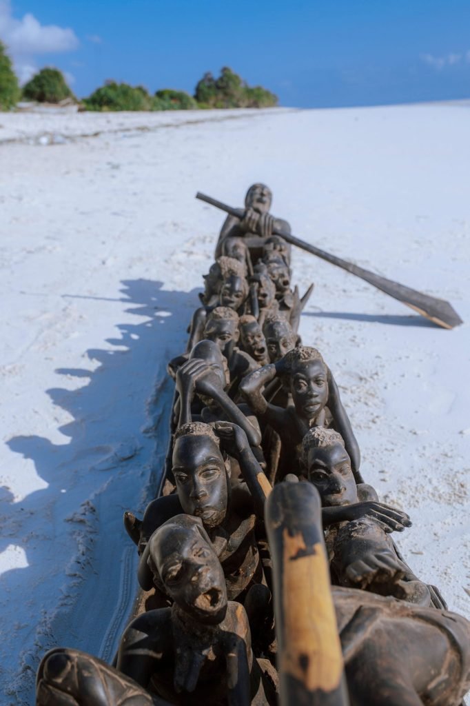 Group photograph of carved furniture and thrones on the beach — 0S7A5004.