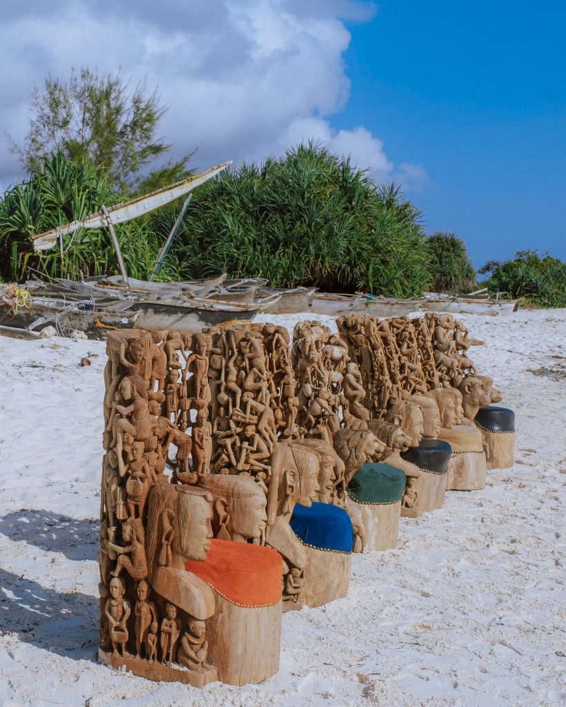 Group photograph of carved furniture and thrones on the beach — 0S7A5023.